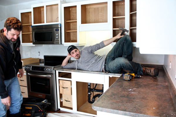 Spencer posing for one more pic before removing old countertops… cynthiaweber.com