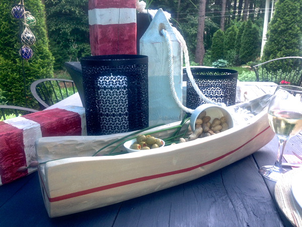 carved boat and DIY beach buoys for relaxed bbq tabletop styling cynthiaweber.com