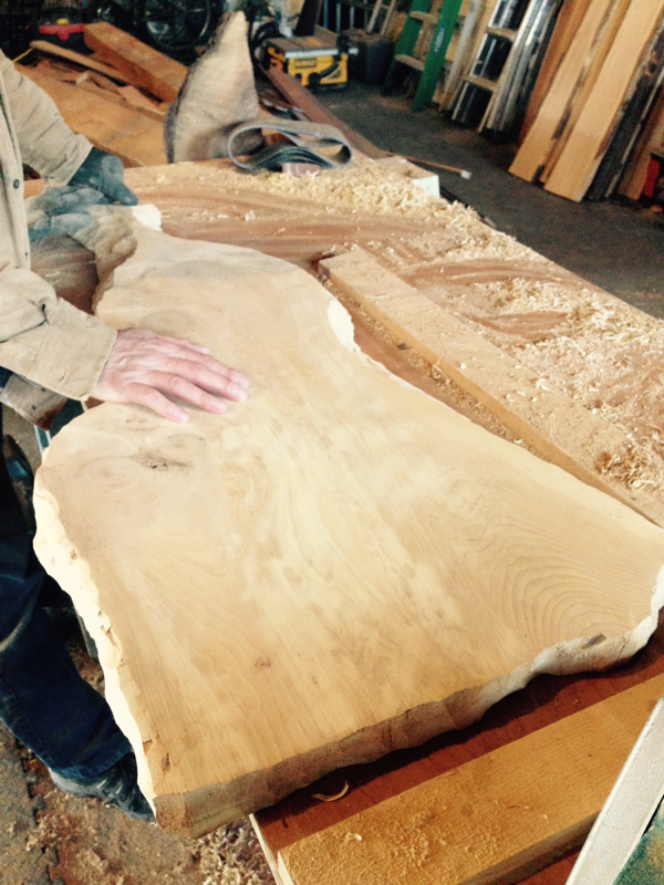 Kent working on a live edge serving board in the barn … Cynthiaweber.com
