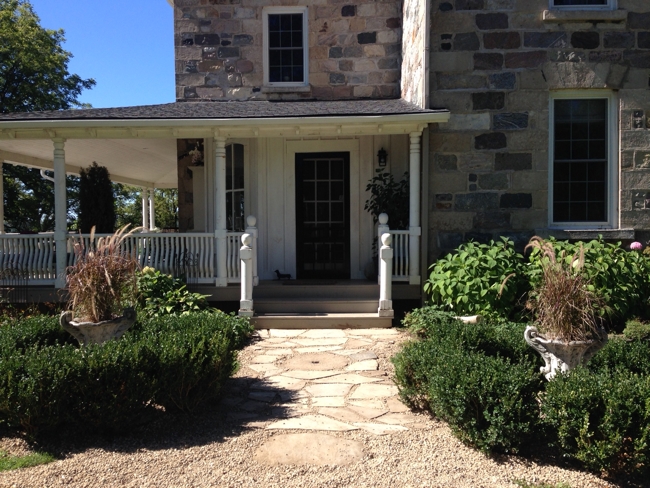 The side door pathway featuring a gristmill stone found buried on the property… Cynthiaweber.com